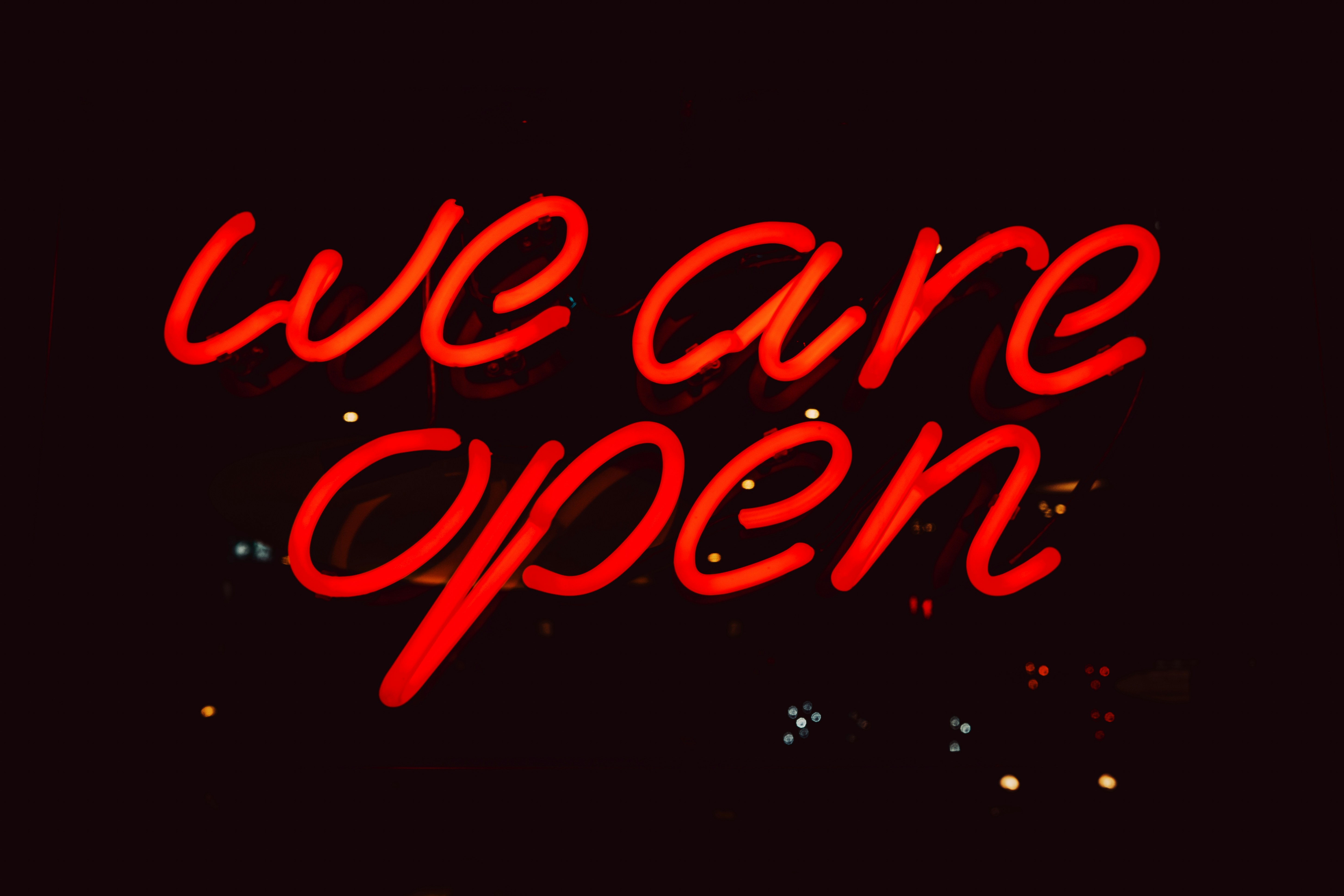a neon sign that says we are open